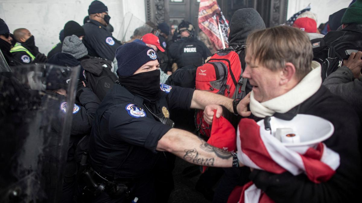 FILE PHOTO: Members of law enforcement clash with pro-Trump protesters, who stormed the U.S. Capitol during a rally to contest the certification of the 2020 U.S. presidential election results by the U.S. Congress, at the U.S. Capitol Building in Washington, D.C., U.S. January 6, 2021. Picture taken January 6, 2021. REUTERS/Ahmed Gaber./File Photo