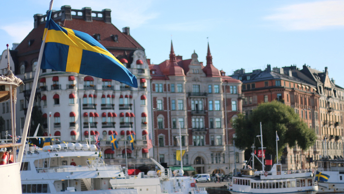 A Swedish flag flutters in front of residential houses in Stockholm, Sweden, September 14, 2023. REUTERS/Marie Mannes