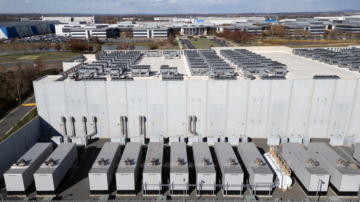 An aerial view shows cooling vent fans on the roof next to generators on the lower level of a Digital Realty data center in Ashburn, Virginia on Nov. 12, 2025. Data centers are the physical infrastructure that make our digital lives possible, yet most people have never seen one up close or understand how they operate. Roughly 12,000 data centers are in operation in the world, with about half in the US, according to Cloudscene, a data center directory. (Andrew Caballero-Reynolds/AFP/Getty Images/TNS)