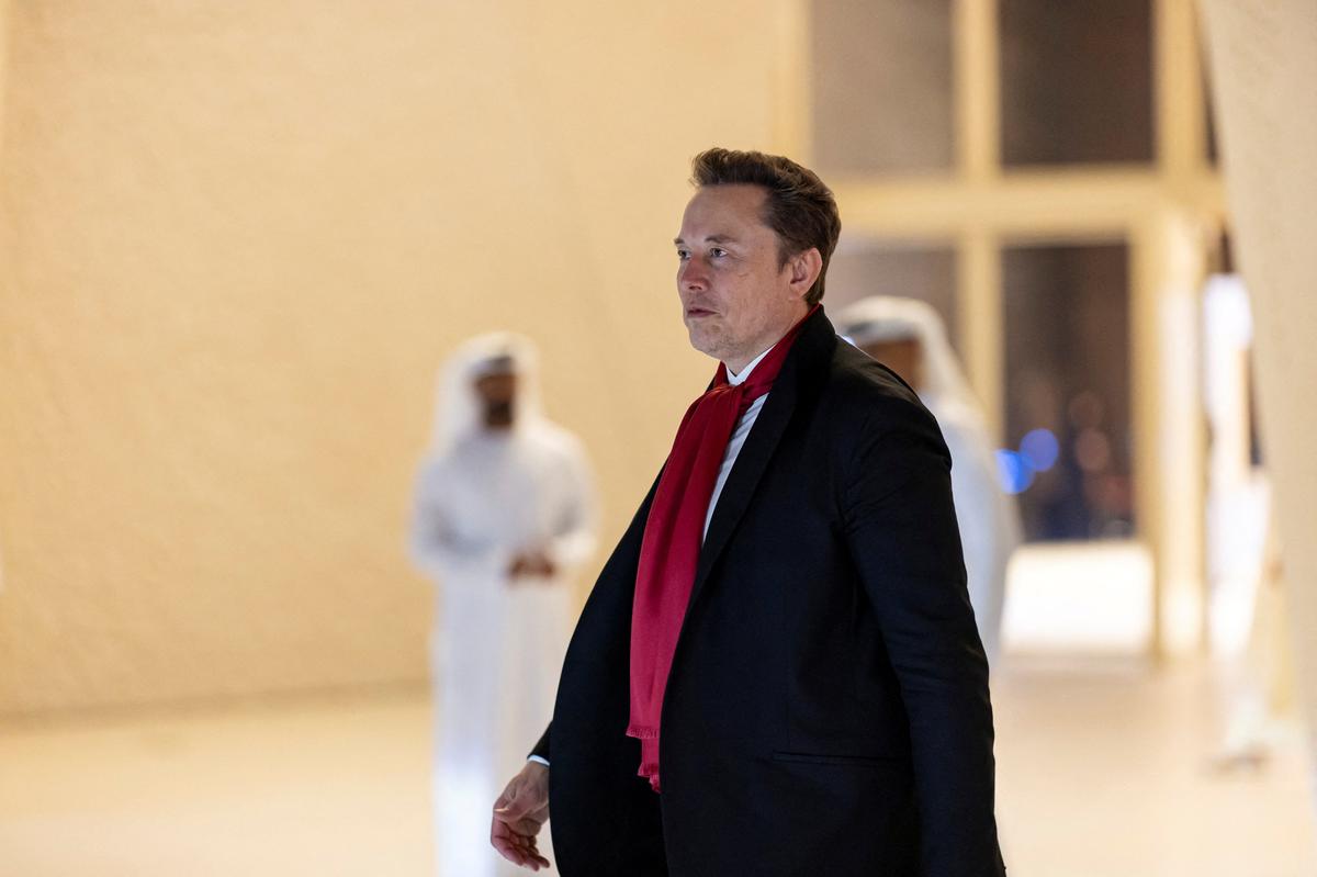 SAADIYAT ISLAND, ABU DHABI, UNITED ARAB EMIRATES - December 20, 2025: Elon Musk, CEO of Tesla and CEO of SpaceX (C), departs after a meeting at Zayed National Museum. Ryan Carter / UAE Presidential Court/Handout via REUTERS