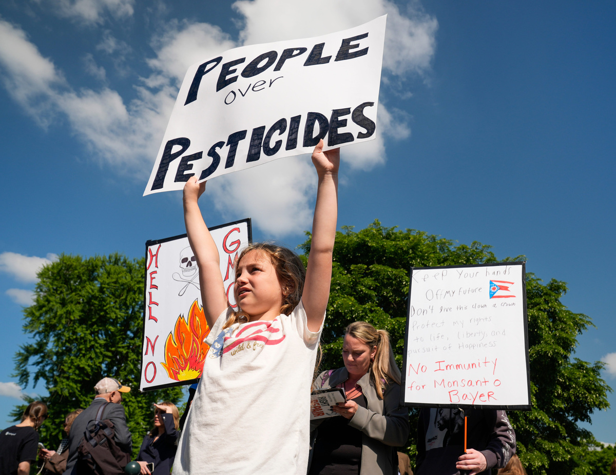 Protestors gather outside the Supreme Court as the Justices hearing arguments in Monsanto Company v. Durnell, on April 27, 2026, in Washington, DC. The Supreme Court will decide whether to block thousands of lawsuits alleging Monsanto failed to warn people that its popular weedkiller could cause cancer.