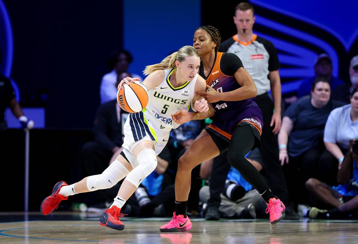  Dallas Wings guard Paige Bueckers dribbles as Phoenix Mercury guard Monique Akoa Makani defends. Kevin Jairaj-Imagn Images
