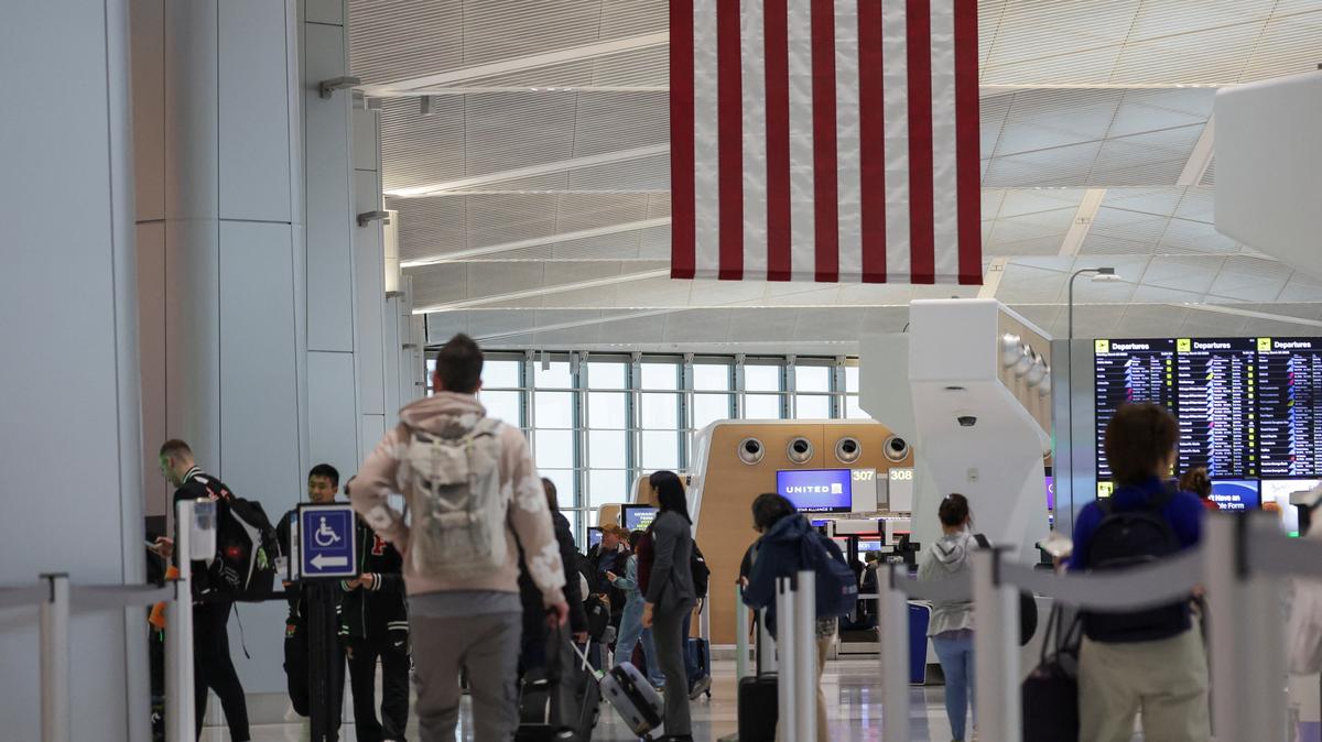 People walk at Newark Liberty International Airport, in Newark, New Jersey,  U.S., March 23, 2026. REUTERS/Jeenah Moon/File Photo