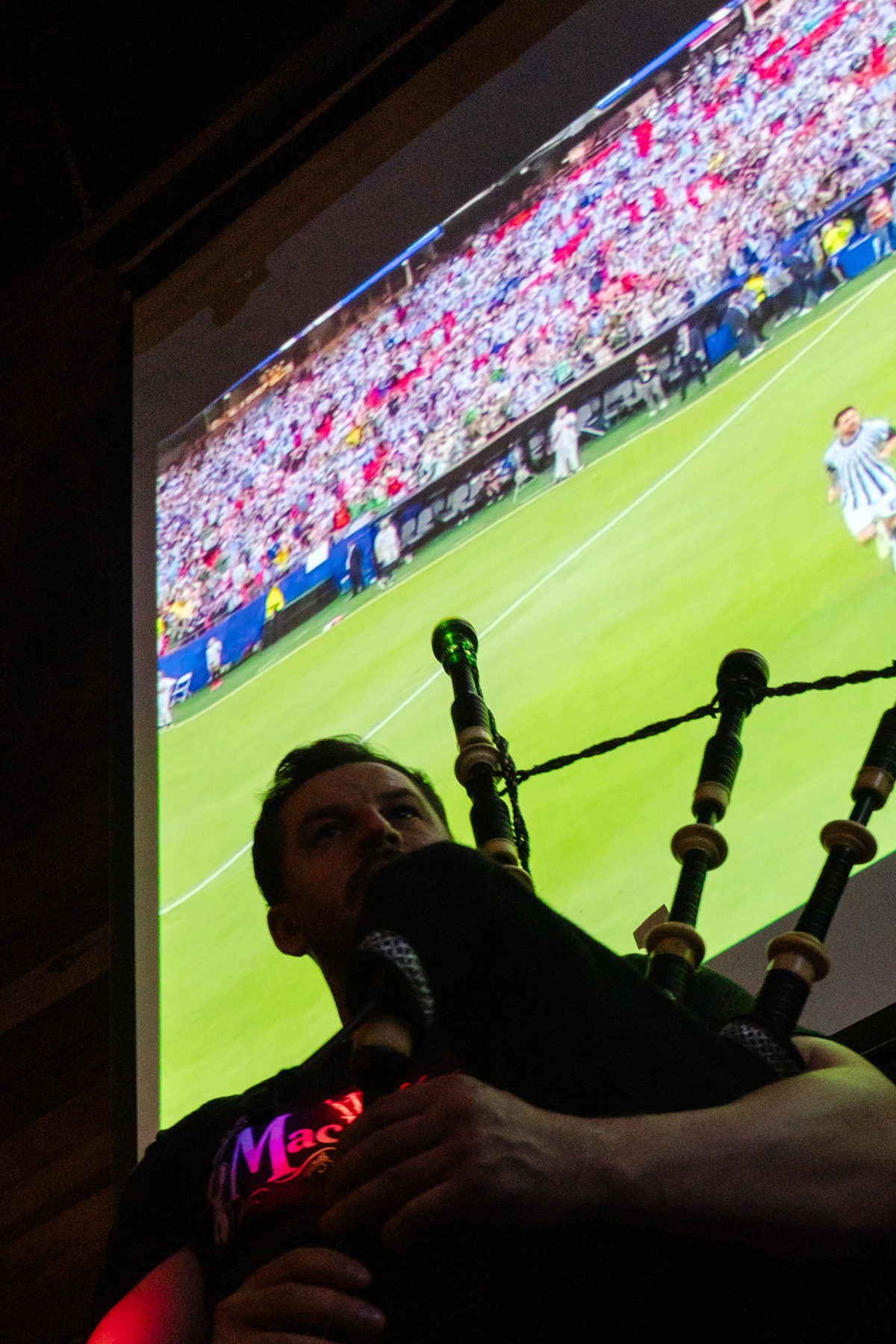 Iain MacGillivray of MacDouble, a musical duo from the Scottish Highlands, plays the bagpipes before the Argentina vs. Algeria World Cup game at The Haven, a Scottish bar in Boston's Jamaica Plain neighborhood, on June 16, 2026. The Tartan Army -- thousands of soccer fans from Scotland, here to see their national team play outside Boston in two matches of the World Cup -- are packing this old city's narrow streets, its subway cars, restaurants and pubs, and filling the air with the cry of bagpipes. (Sophie Park/The New York Times)