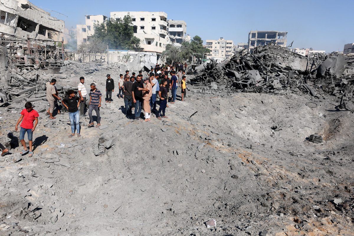Palestinians inspect the site of an Israeli strike on a metal foundry in Gaza City, July 12, 2026. REUTERS/Dawoud Abu Alkas