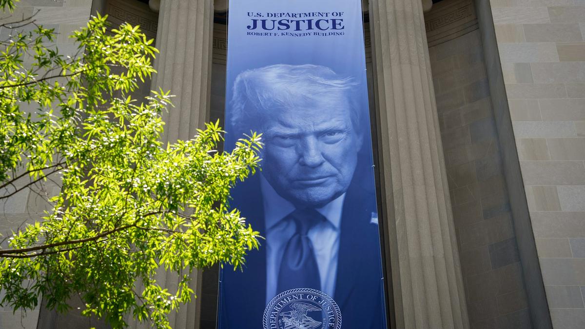A banner featuring President Trump on the outside of the DOJ building in Washington, D.C. 