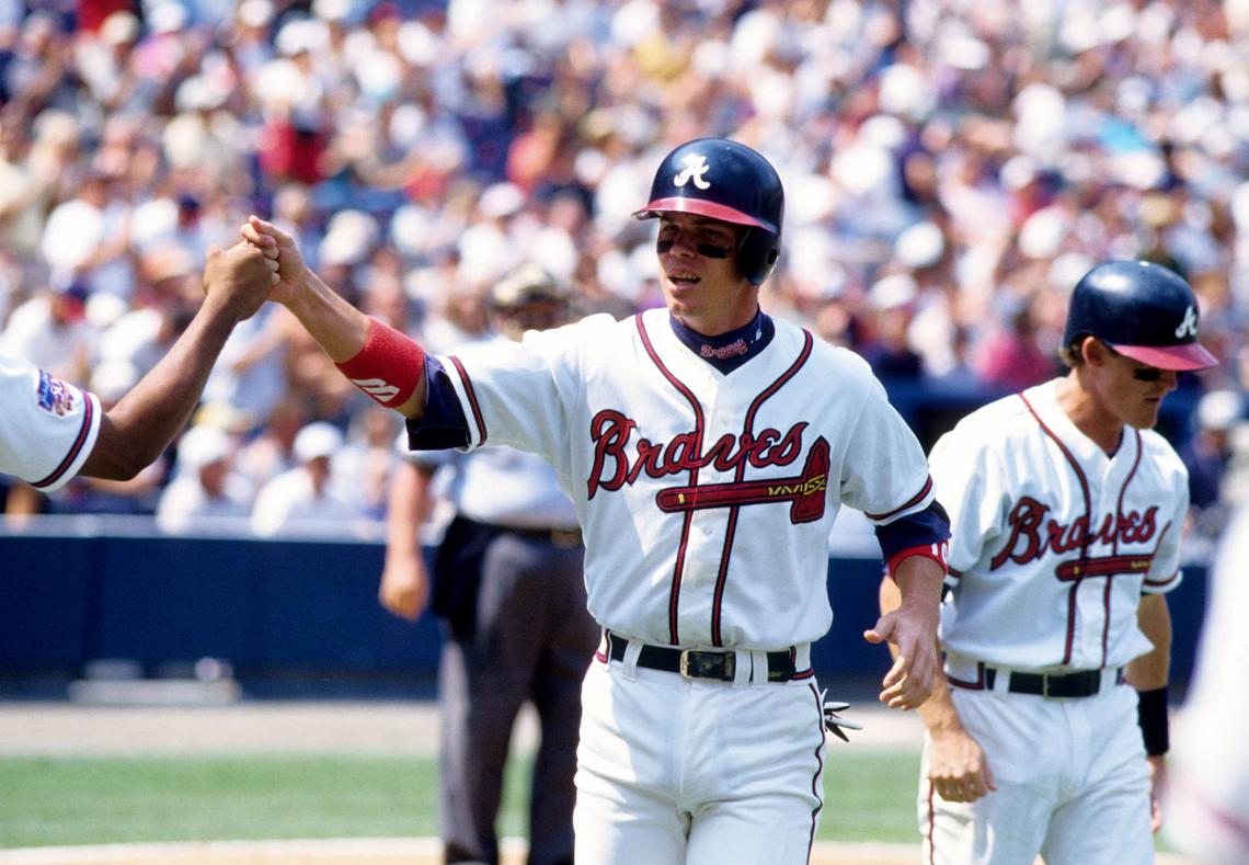  Atlanta Braves third baseman Chipper Jones fist bumps a teammate during the 1997 season at Turner Field. RVR Photos-USA TODAY Sports via Imagn Images