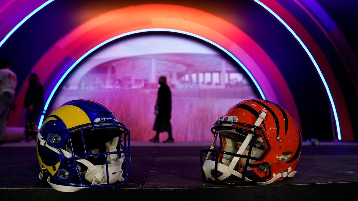 Los Angeles Rams and Cincinnati Bengals helmets rest on a stage inside the NFL Experience, an interactive fan show, Friday, Feb. 4, 2022, at the Los Angeles Convention Center in Los Angeles. The Los Angeles Rams are scheduled to play the Cincinnati Bengals in the Super Bowl NFL football game Feb. 13 in Inglewood, Calif. (AP Photo/Marcio Jose Sanchez)