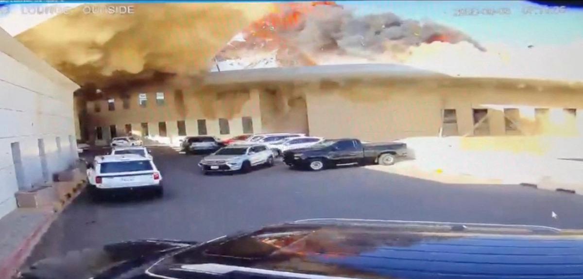 A CCTV footage shows a car leaving a parking lot as fire and smoke rise following a strike on Kuwait International Airport in Kuwait City, Kuwait, June 3, 2026, in this screengrab from a video. Civil Aviation Kuwait/Handout via REUTERS