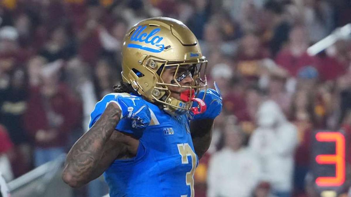  Nov 29, 2025; Los Angeles, California, USA; UCLA Bruins wide receiver Kwazi Gilmer (3) celebrates after scoring on a 2-yard touchdown reception against Southern California Trojans cornerback Marcelles Williams (25) at United Airlines Field at Los Angeles Memorial Coliseum. Mandatory Credit: Kirby Lee-Imagn Images | Kirby Lee-Imagn Images 
