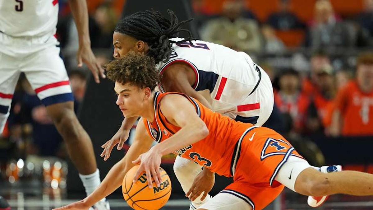  Apr 4, 2026; Indianapolis, IN, USA; Illinois Fighting Illini guard Keaton Wagler (23) controls the ball against UConn Huskies guard Silas Demary Jr. (2) during the second half of a semifinal of the Final Four of the men's 2026 NCAA Tournament at Lucas Oil Stadium. Mandatory Credit: Bob Donnan-Imagn Images | Bob Donnan-Imagn Images 