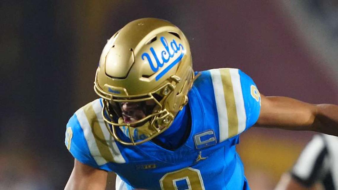  Nov 29, 2025; Los Angeles, California, USA; UCLA Bruins quarterback Nico Iamaleava (9) is tackled by Southern California Trojans linebacker Eric Gentry (18) in the second half at United Airlines Field at Los Angeles Memorial Coliseum. Mandatory Credit: Kirby Lee-Imagn Images | Kirby Lee-Imagn Images 