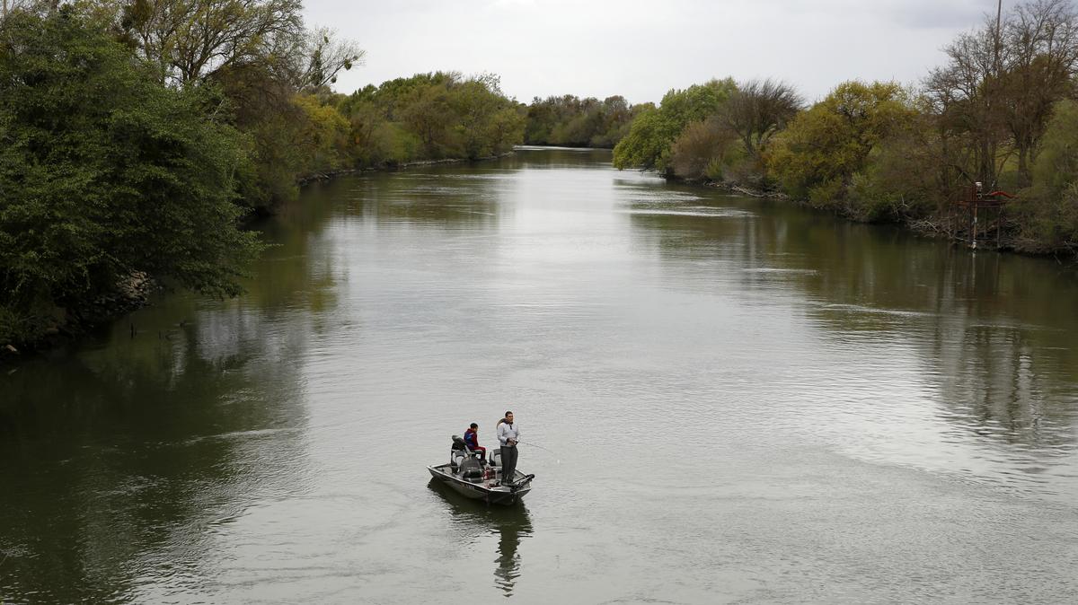 California Water Delta Tunnel. People fish in the Sacramento-San Joaquin River Delta's Elk Slough near Courtland, California, in 2020.