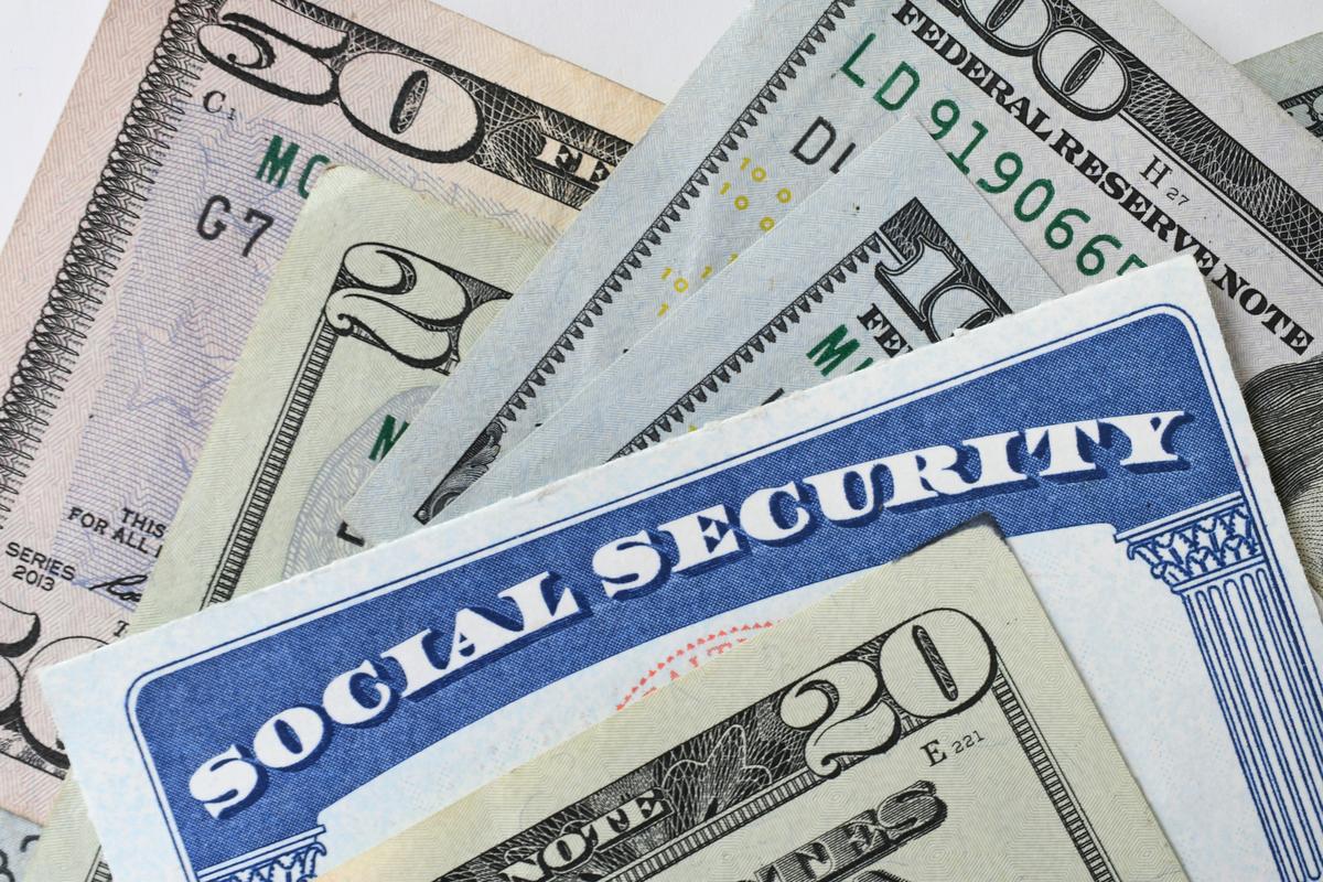  A Social Security card with U.S. dollar bills. Source: Getty Images. 