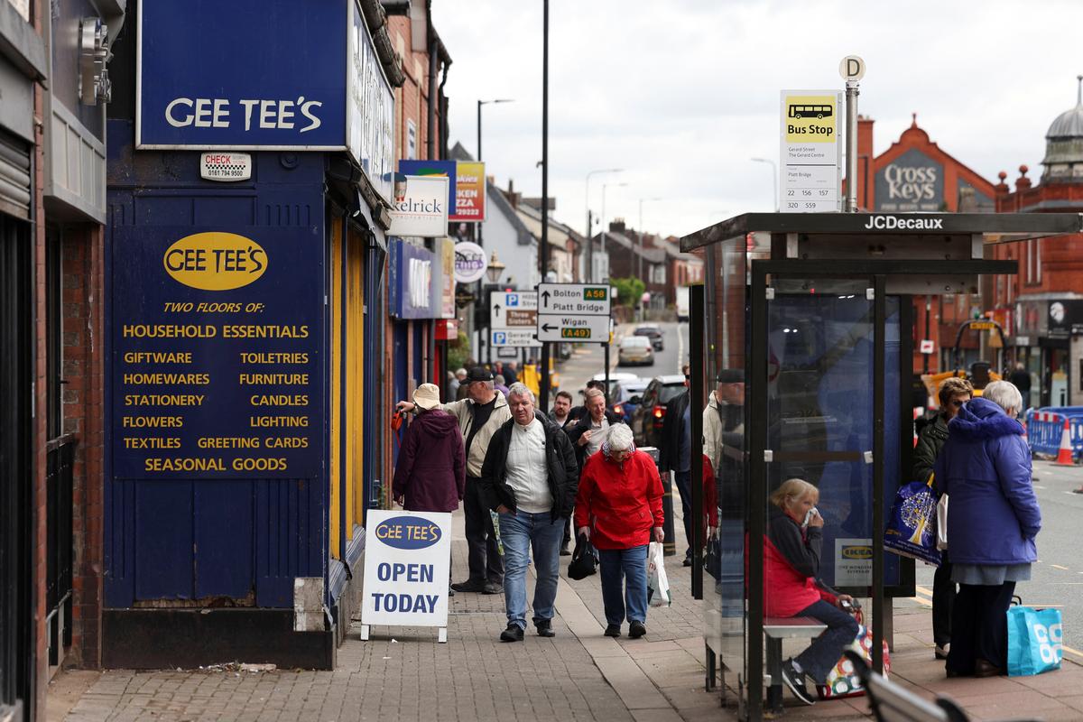 People walk along the high street, ahead of the Makerfield by-election, in Ashton-in-Makerfield, Britain, May 20, 2026. REUTERS/Temilade Adelaja
