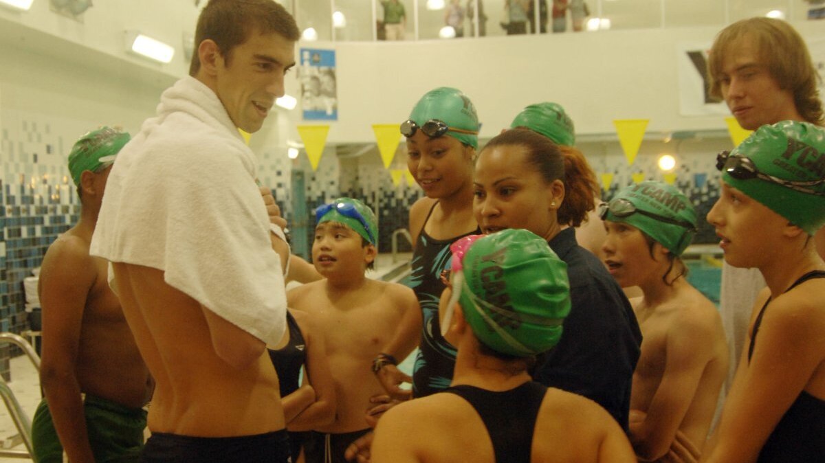 Olympic swim champ Michael Phelps talks with children at a YMCA in New York City on August 28, 2008. On June 6, 1844, the Young Men's Christian Association -- YMCA -- was founded in London. File Photo by Ezio Petersen/UPI