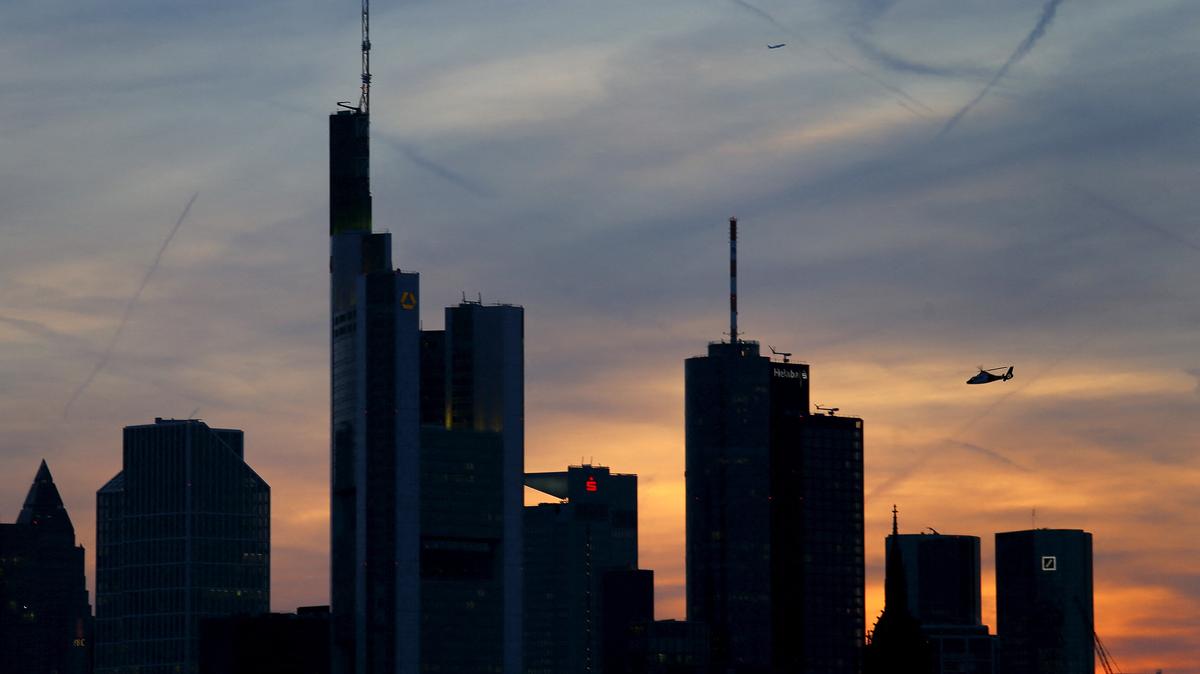 FILE PHOTO: The famous skyline with its banking district is pictured as a rescue helicopter flies by in Frankfurt early evening April 13, 2015. The European Central Bank's governing council will meet in Frankfurt on Wednesday, April 15.  REUTERS/Kai Pfaffenbach/File Photo