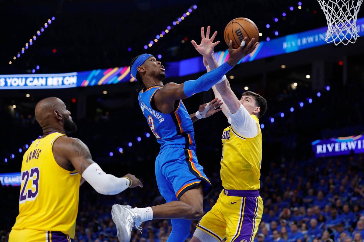  May 5, 2026; Oklahoma City, Oklahoma, USA; Oklahoma City Thunder guard Shai Gilgeous-Alexander (2) goes up for a basket as Los Angeles Lakers forward Jake LaRavia (12) defends in the second half during game one of the second round of the 2026 NBA Playoffs at Paycom Center. Mandatory Credit: Alonzo Adams-Imagn Images 