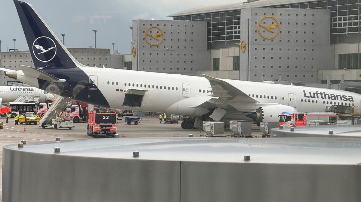 A Lufthansa Dreamliner aircraft rests on its nose in front of a terminal at Frankfurt Airport Thursday, June 4, 2026, after the nose landing gear collapsed. Employees were injured in the incident. (Mike Seeboth/dpa/TNS)