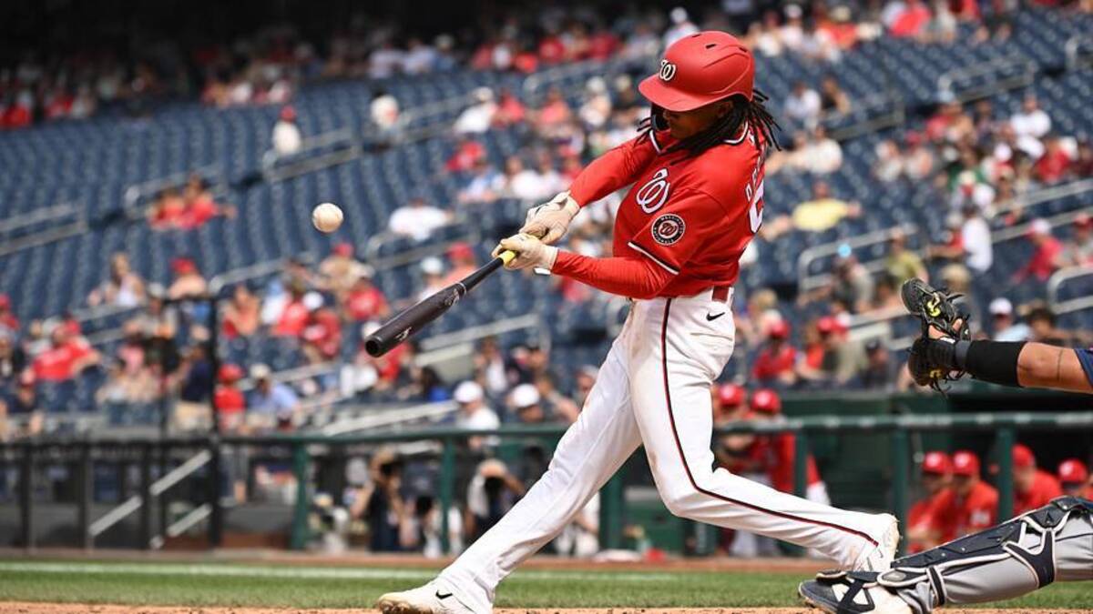  Jun 14, 2026; Washington, District of Columbia, USA; Washington Nationals shortstop CJ Abrams (5) hits the ball into play against the Seattle Mariners during the eighth inning at Nationals Park. Mandatory Credit: Rafael Suanes-Imagn Images | Rafael Suanes-Imagn Images 