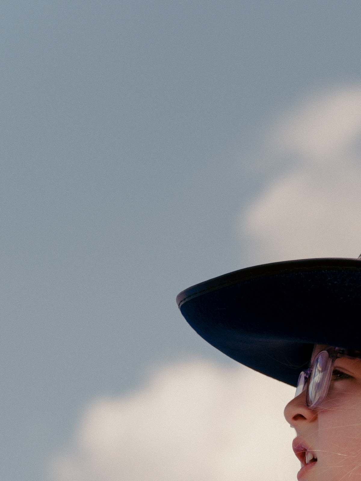 Lydia, 4, sits on her father Austin Moore's shoulders during a Civil War reenactment in Gettysburg, Pa., on July 4, 2026. Though it was muggy and miserably hot in many parts of the country, the day was marked with the usual American exuberance, with fighter jets, tall ships, parachutists and flag-festooned pick-up trucks. (Caroline Gutman/The New York Times)