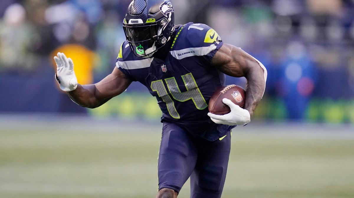 Seattle Seahawks wide receiver DK Metcalf carries the ball against the Detroit Lions during the second half of an NFL football game, Sunday, Jan. 2, 2022, in Seattle. (AP Photo/Elaine Thompson)