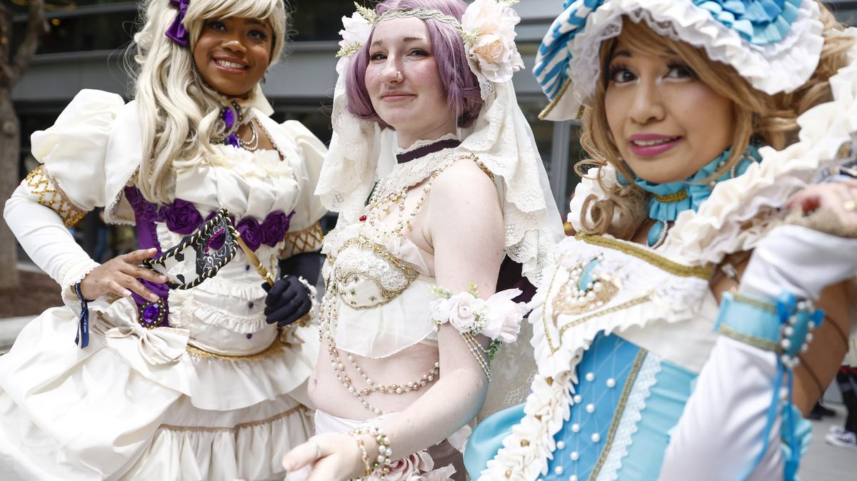 (Left to right) Vanessa Blake, of Hayward, Emily Heary, of Reno, and Charie Okuma, of Union City, stand for a picture dressed up in outfits inspired by Sakizo, a Japanese illustrator, at FanimeCon at San Jose McEnery Convention Center in San Jose, Calif., on Sunday, May 28, 2023. Blake, Heary, and Okuma handmade their outfits. (Shae Hammond/Bay Area News Group)