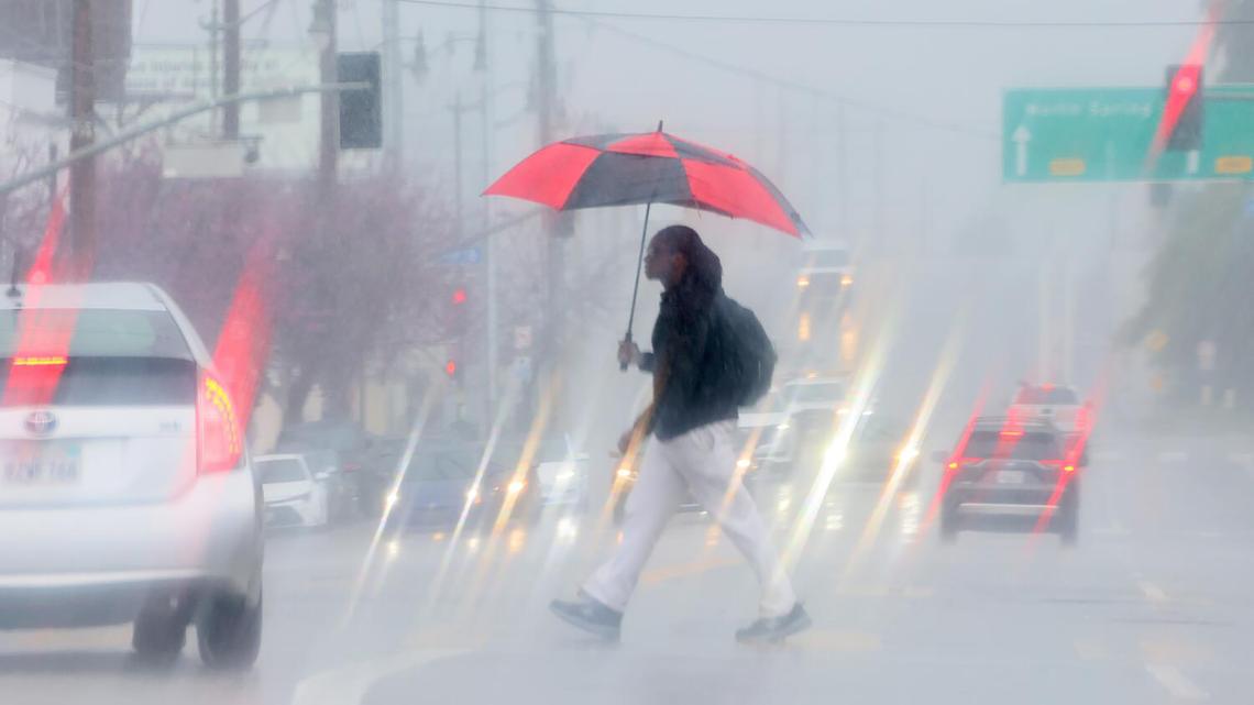 A pedestrian crosses Spring Street in downtown Los Angeles during a downpour on Feb. 19, 2026. (Allen J. Schaben/Los Angeles Times/TNS)