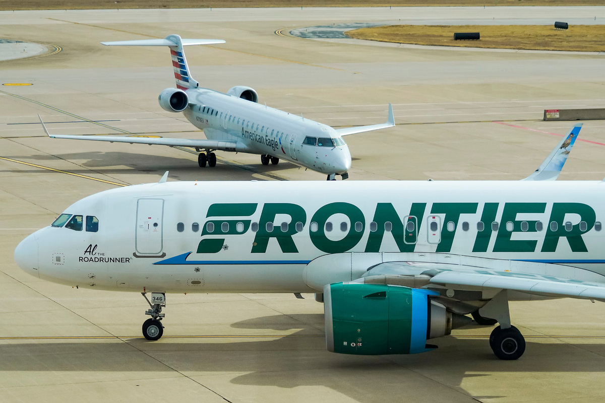 A Frontier Airlines plane taxis in Dallas.
