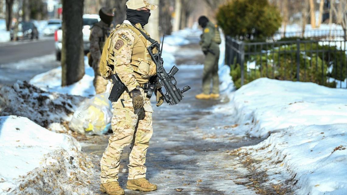 Minnesota charges ICE agent with assault for pointing gun 