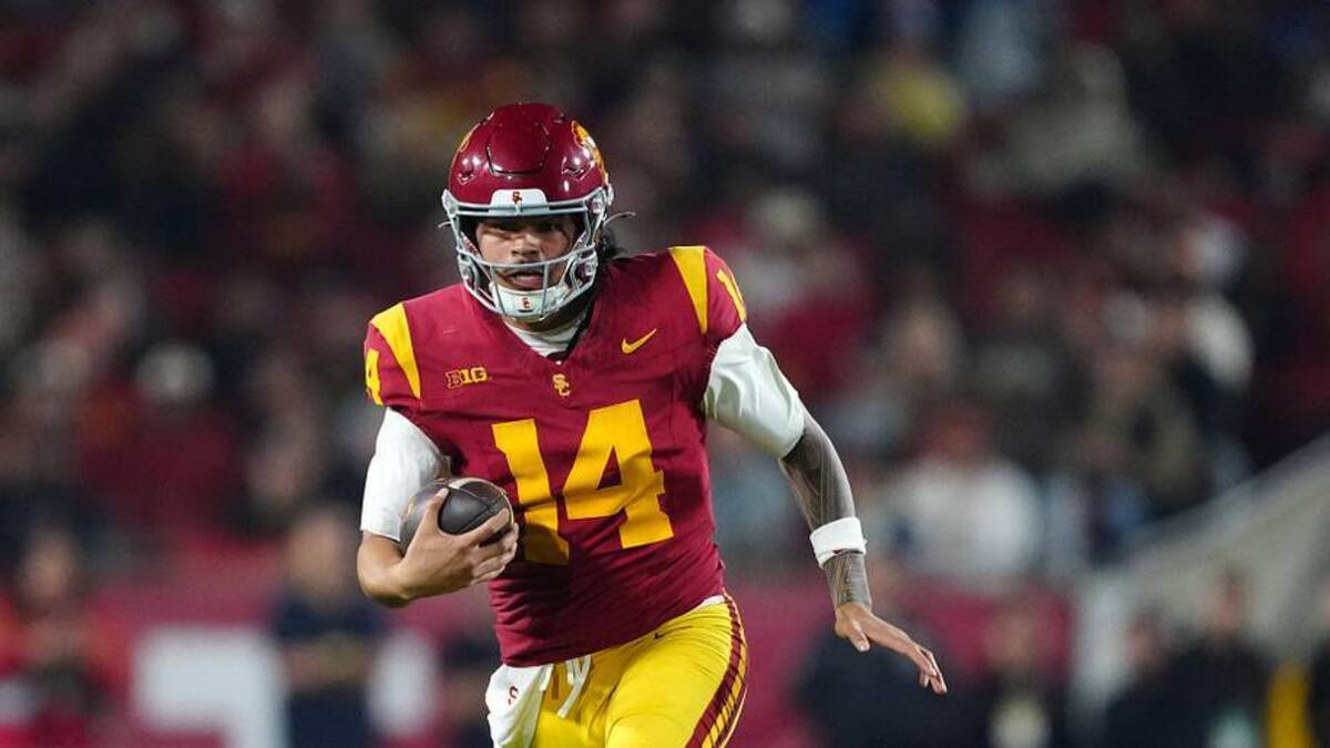  Nov 29, 2025; Los Angeles, California, USA; Southern California Trojans quarterback Jayden Maiava (14) carries the ball against the UCLA Bruins in the first half at United Airlines Field at Los Angeles Memorial Coliseum. Mandatory Credit: Kirby Lee-Imagn Images | Kirby Lee-Imagn Images 