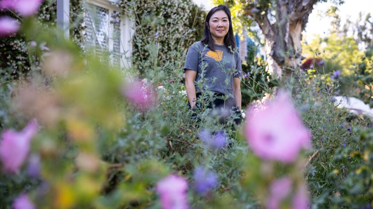LOS ANGELES, CA - MAY 14, 2026: Julia Lee, Loyola Marymount University Professor, poses for a portrait in her garden at her home in Cheviot Hills on Thursday, May 14, 2026, in Los Angeles, CA. Lee decided in 2022 to remove her front lawn in Cheviot Hills and replace it with native and drought-tolerant plants. (Kayla Bartkowski / Los Angeles Times)