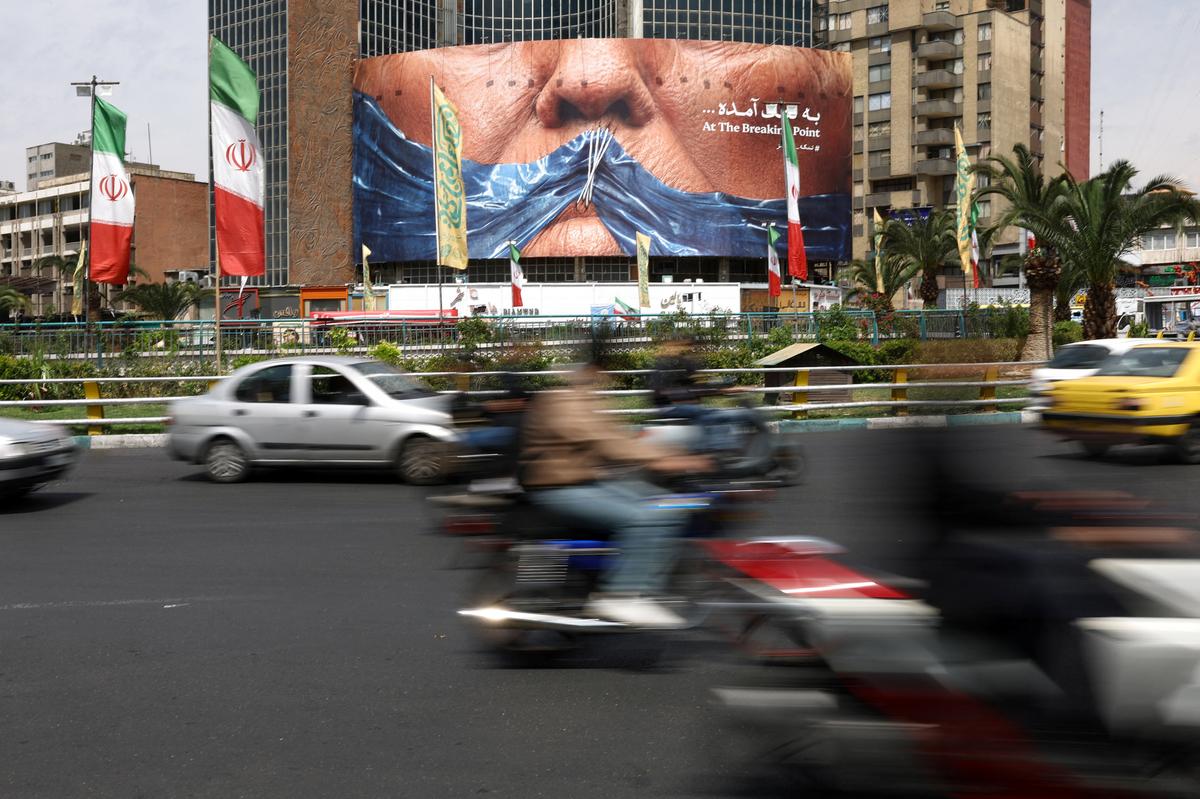 People drive past an anti-U.S. billboard depicting U.S. President Donald Trump and the Strait of Hormuz, in Tehran, Iran, May 2, 2026. Majid Asgaripour/WANA (West Asia News Agency) via REUTERS ATTENTION EDITORS - THIS PICTURE WAS PROVIDED BY A THIRD PARTY