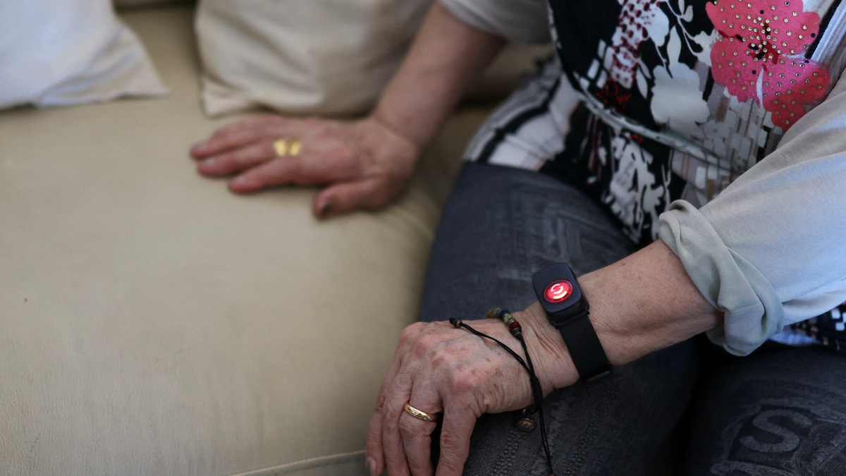 Dina Gazzella, 85, wears an electronic bracelet that monitors her heart rate and sleep patterns, allows her to call for help in an emergency, and enables a team of social workers to monitor her remotely, in Rome, Italy, June 26, 2026. The device is part of a support scheme for the elderly introduced last year by Rome's municipality, which local authorities describe as an important preventive healthcare tool, particularly during the Europe-wide heatwave that has pushed temperatures in Rome above 30 degrees Celsius. REUTERS/Yara Nardi