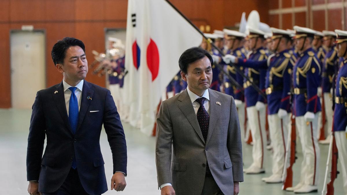 Japan's Defense Minister Shinjiro Koizumi and South Korea's Defense Minister Ahn Gyu-back review the troops during a ceremony at the headquarters of the Japan Maritime Self-Defense Force, in Yokosuka District, Tokyo, January 30, 2026.     Eugene Hoshiko/Pool via REUTERS