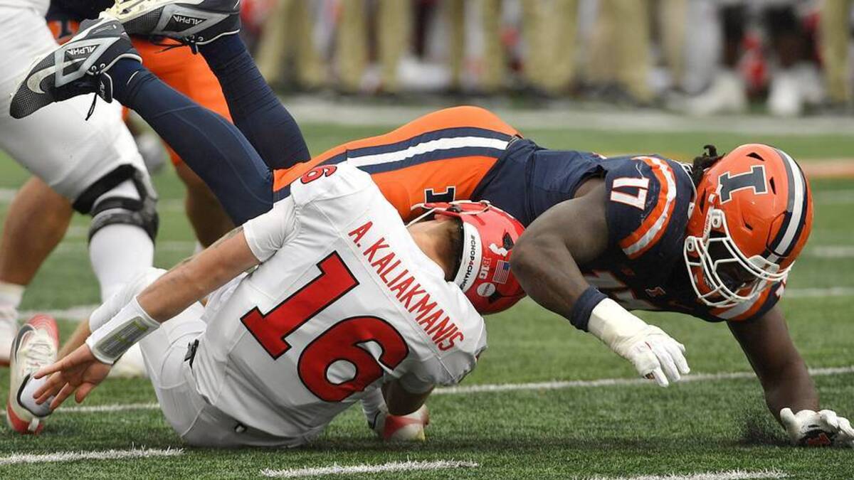 Nov 1, 2025; Champaign, Illinois, USA; Illinois Fighting Illini linebacker Gabe Jacas (17) sacks Rutgers Scarlet Knights quarterback Athan Kaliakmanis (16) during the first half at Memorial Stadium. Mandatory Credit: Ron Johnson-Imagn Images | IMAGN IMAGES via Reuters Connect 
