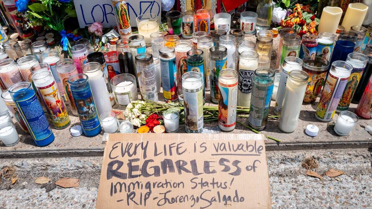 Flowers and candles are situated at a makeshift memorial site where Mexican immigrant Lorenzo Salgado Araujo was killed on July 9 in Houston.