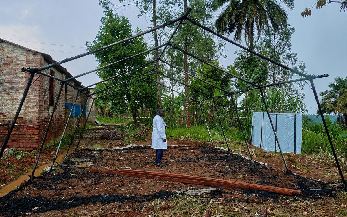 Medical Director of Mungwalu General Hospital Richard Lokudu speaks to Reuters next to the burned remains of a destroyed Médecins Sans Frontières (MSF) emergency isolation tent at the Mongbwalu General Referral Hospital as aid agencies intensify efforts to contain an Ebola outbreak caused by the Bundibugyo virus in Mongbwalu, Djugu Territory of Ituri province, Democratic Republic of Congo, May 23, 2026. REUTERS/Gradel Muyisa Mumbere     TPX IMAGES OF THE DAY