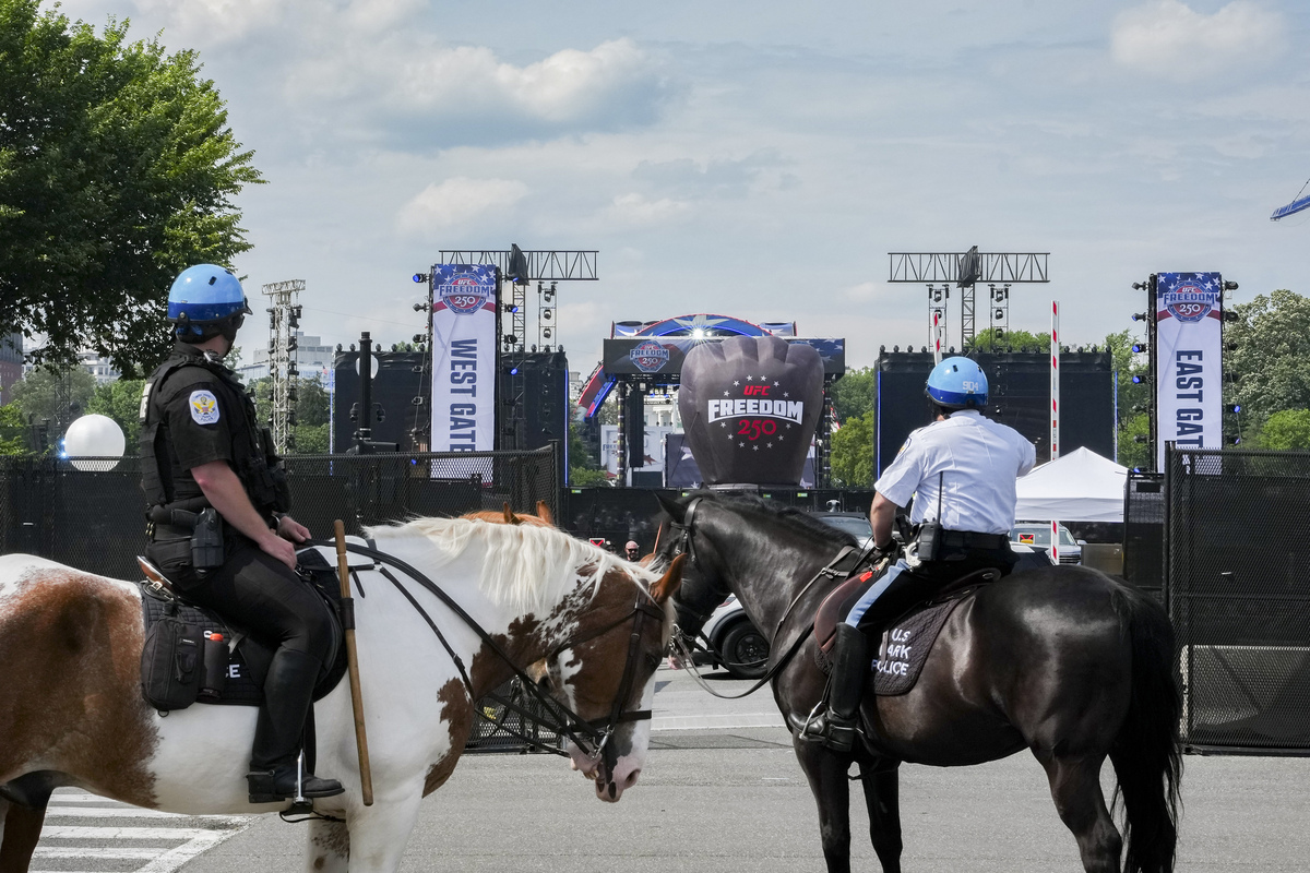 Police officers patrol the area ahead of a UFC event hosted by President Donald Trump for his 80th birthday on the South Lawn of the White House in Washington, on Sunday, June 14, 2026. President Trump's decision to host Ultimate Fighting Championship bouts at the White House on Sunday puts him at the center of a sport that is popular with many young men -- a demographic that swung toward him in the 2024 election but has since shifted away. (Alex Kent/The New York Times)