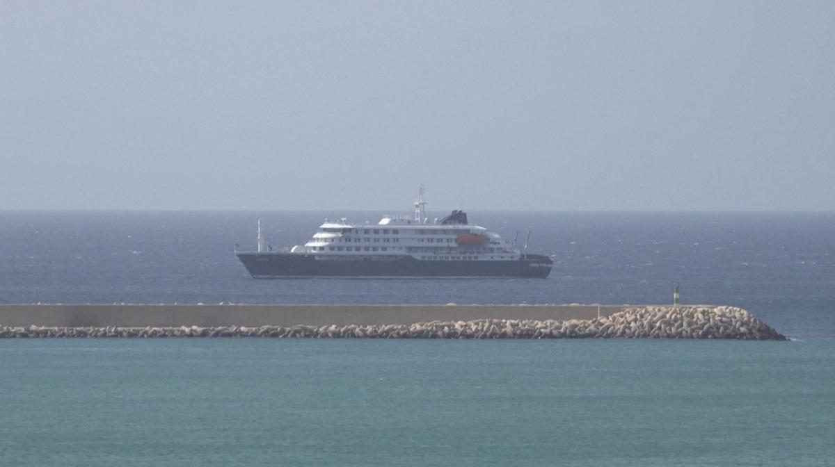 Cruise ship MV Hondius docks off Cape Verde port, as passengers were not allowed off the ship, while health authorities investigated suspected cases of hantavirus aboard the vessel, in Praia Port, Cape Verde, in this screengrab obtained from a video, May 4, 2026. REUTERS TV via REUTERS