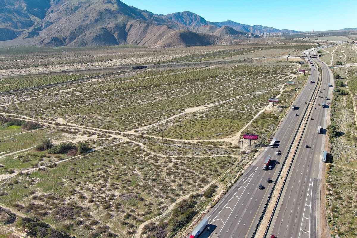 A massive warehouse and industrial complex could be built at the western entrance to the Coachella Valley, where Interstate 10 (seen at right looking west) meets Highway 111. The parcel is owned by the Agua Caliente Band of Cahuilla Indians.