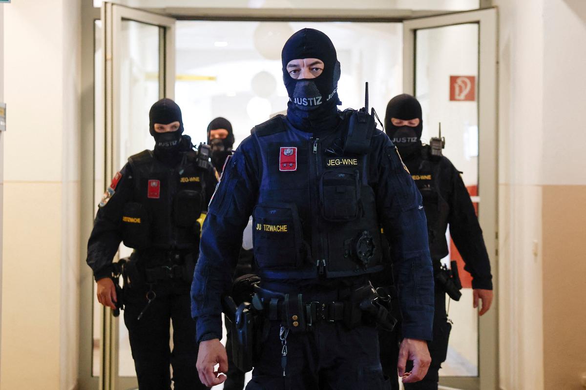 Police escort Austrian defendant Beran A, who pleaded guilty to planning an attack on U.S. singer Taylor Swift's Vienna concert in 2024, in a courtroom for his trial in Wiener Neustadt, Austria, May 28, 2026. REUTERS/Lisa Leutner