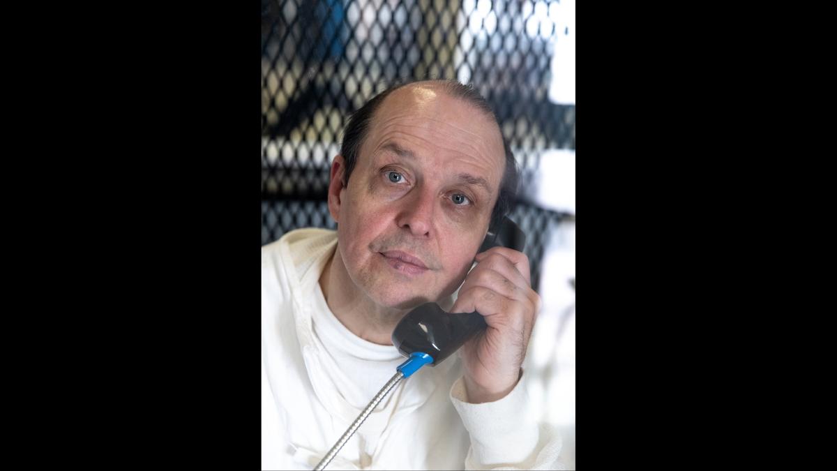 Robert Roberson photographed through plexiglass at TDCJ Polunsky Unit, on Dec. 19, 2023 in Livingston, Texas.