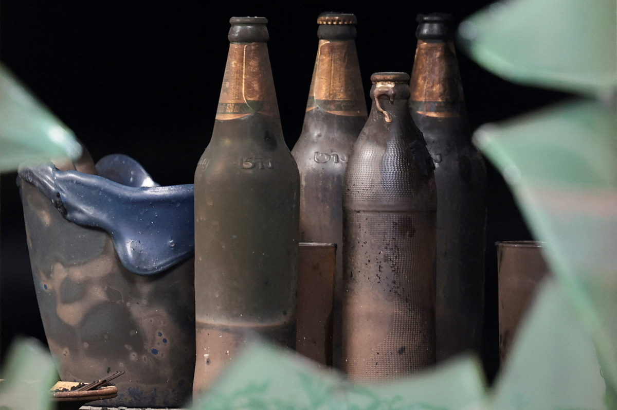 Burnt bottles inside the Rong Beer Na Lat Phrao bar, a day after the deadly fire, in Bangkok, Thailand, July 14, 2026. REUTERS/Chalinee Thirasupa