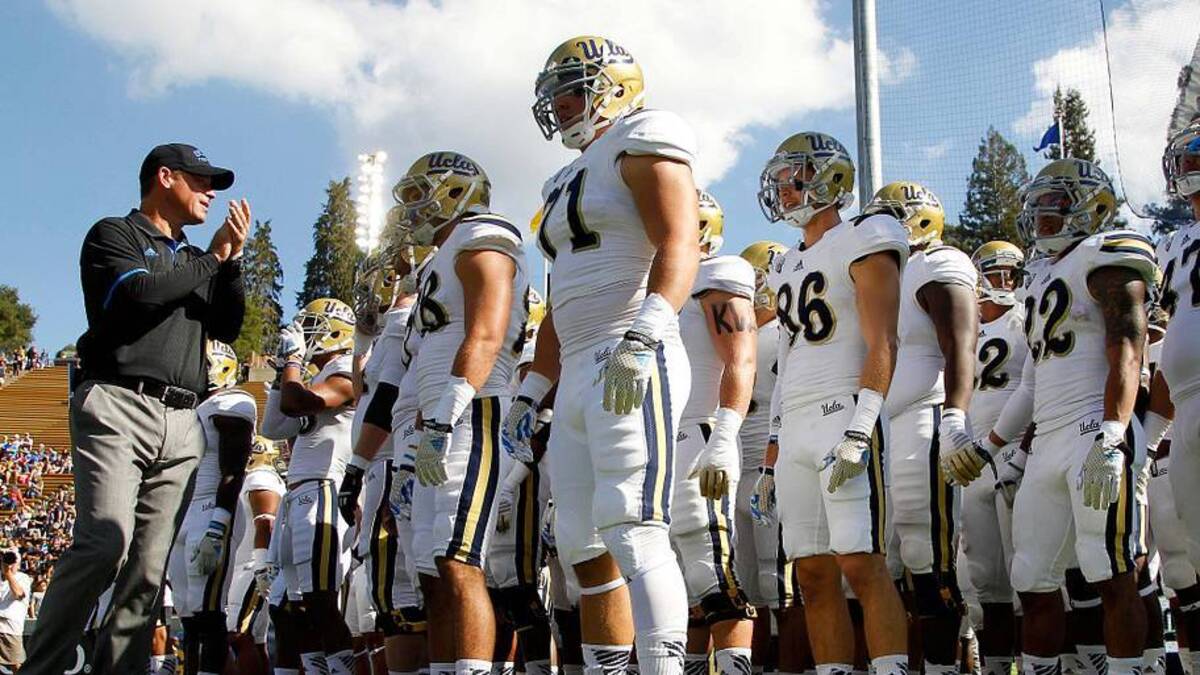  Oct 18, 2014; Berkeley, CA, USA; UCLA Bruins head coach Jim Mora Jr. encourages his team before the start of the game against the California Golden Bears at Memorial Stadium. Mandatory Credit: Cary Edmondson-Imagn Images | Cary Edmondson-Imagn Images 