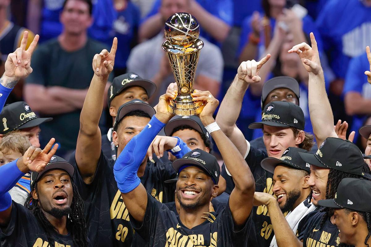  Jun 22, 2025; Oklahoma City, Oklahoma, USA; Oklahoma City Thunder guard Shai Gilgeous-Alexander (2) holds up his NBA Finals Bill Russell MVP trophy at the end of game seven of the 2025 NBA Finals after defeating the Indiana Pacers at Paycom Center. Mandatory Credit: Alonzo Adams-Imagn Images 