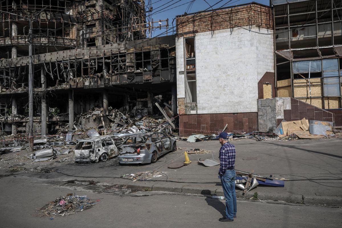 A man observes a destroyed shopping mall, which was hit during yesterday’s Russian missile and drone attack, amid Russia's attack on Ukraine, in Kyiv, Ukraine, May 25, 2026. REUTERS/Alina Smutko