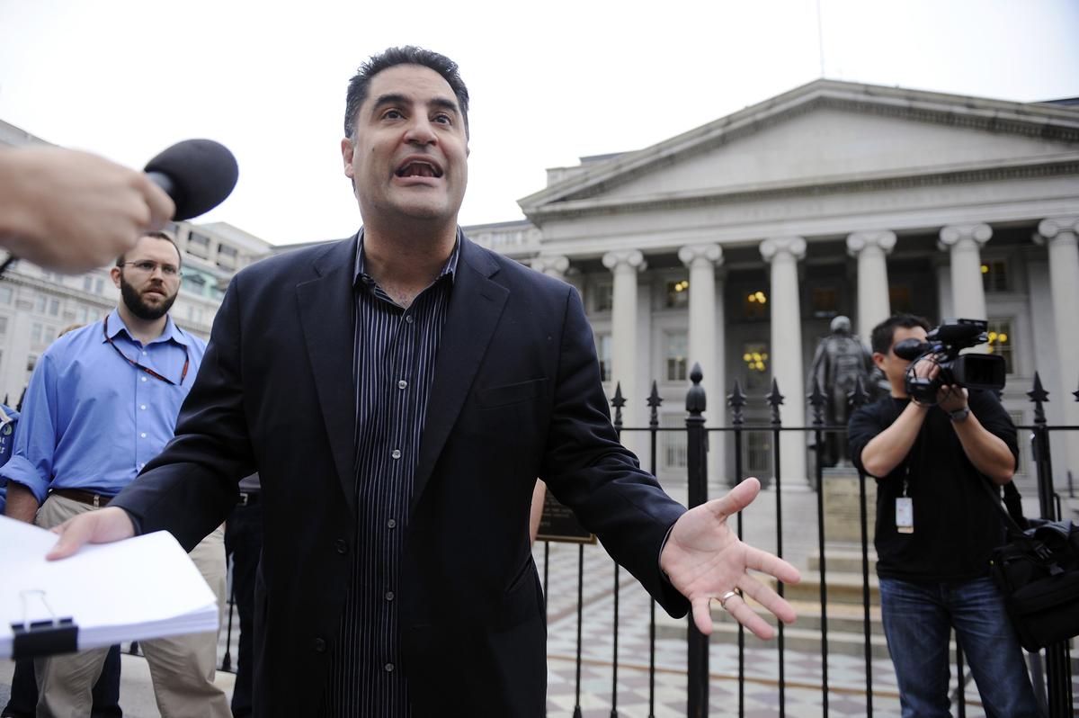 The Young Turks radio show host Cenk Uygur (C) leads a protest of government bailout money given to Goldman Sachs, with listeners gathered in front of the US Treasury building in Washington, June 9, 2010. REUTERS/Jonathan Ernst/ File Photo