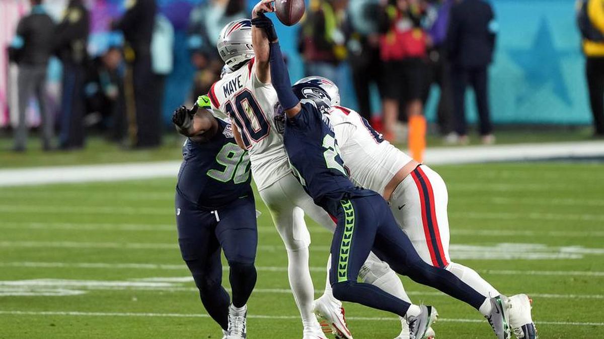  Feb 8, 2026; Santa Clara, CA, USA; Seattle Seahawks cornerback Devon Witherspoon (center right) forces a fumble by New England Patriots quarterback Drake Maye (10) during the fourth quarter in Super Bowl LX at Levi's Stadium. Mandatory Credit: Darren Yamashita-Imagn Images | Darren Yamashita-Imagn Images 