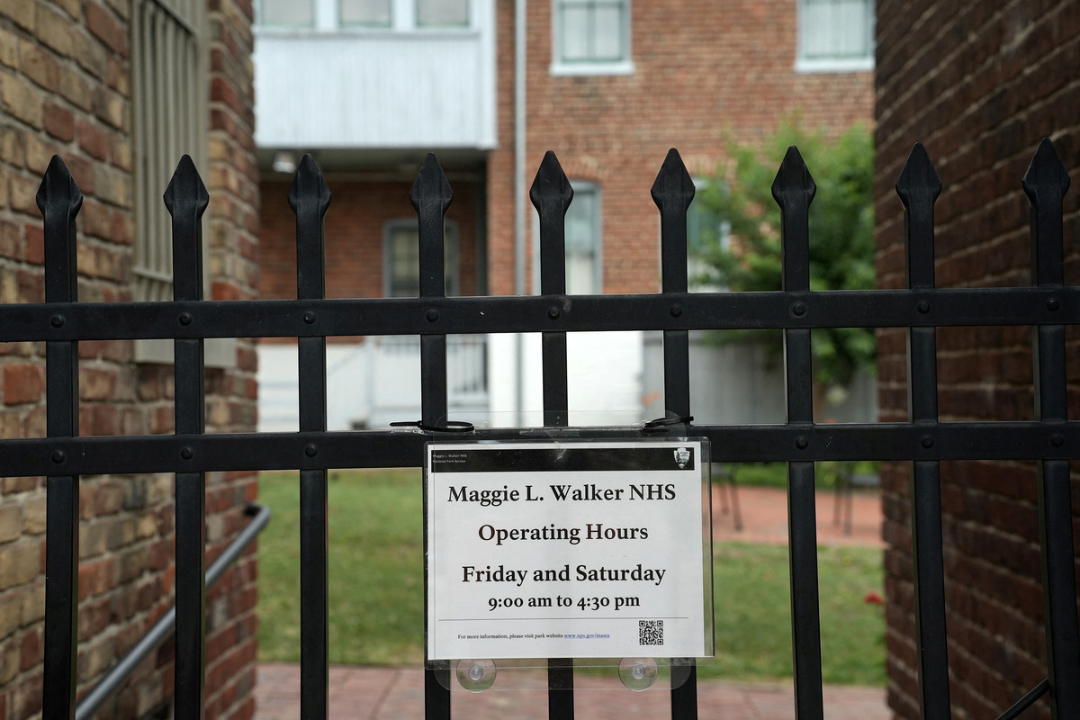 An operating hours sign at the Maggie Walker National Historical Site in Richmond, Virginia, U.S., June 10, 2026.   REUTERS/Jay Paul